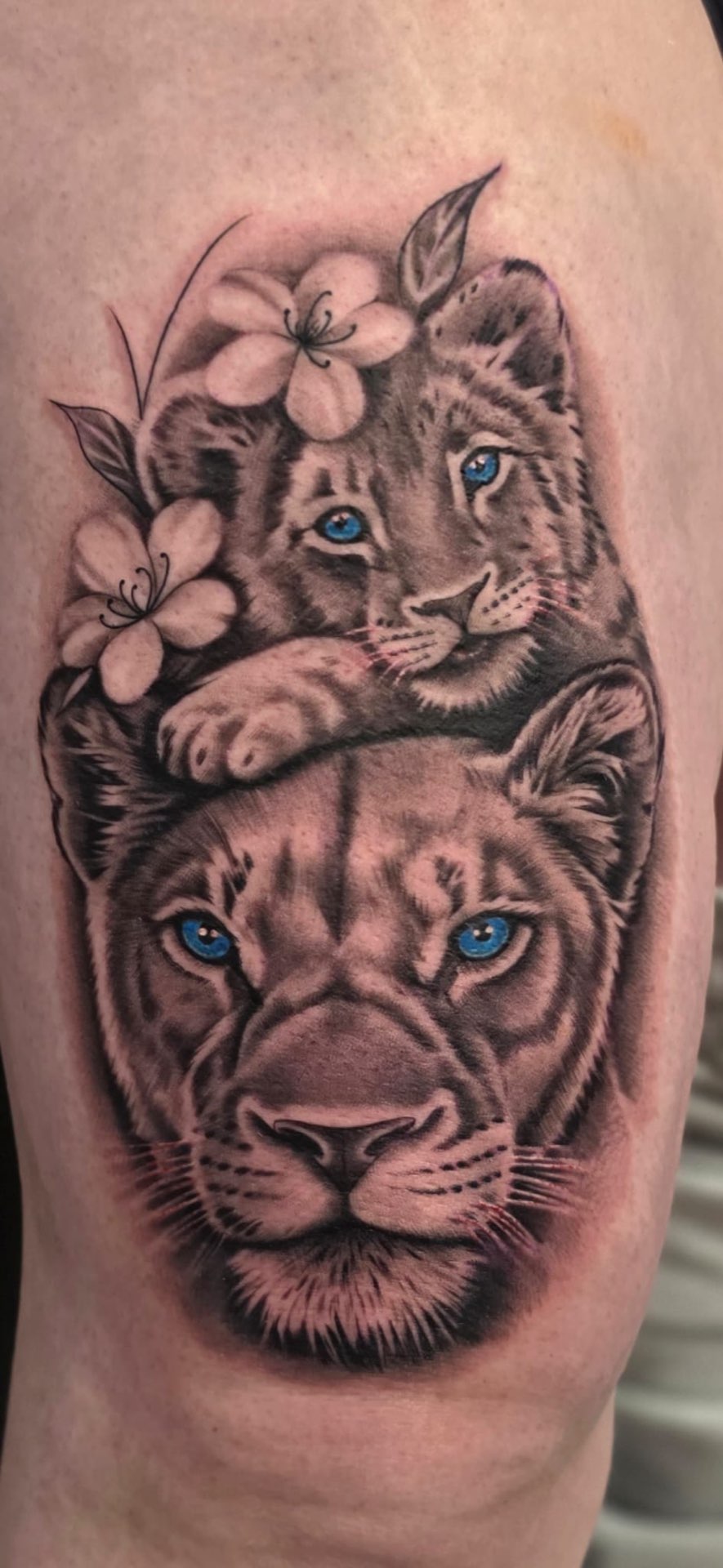 Lioness and cub thigh piece with blue eyes and cherry blossoms