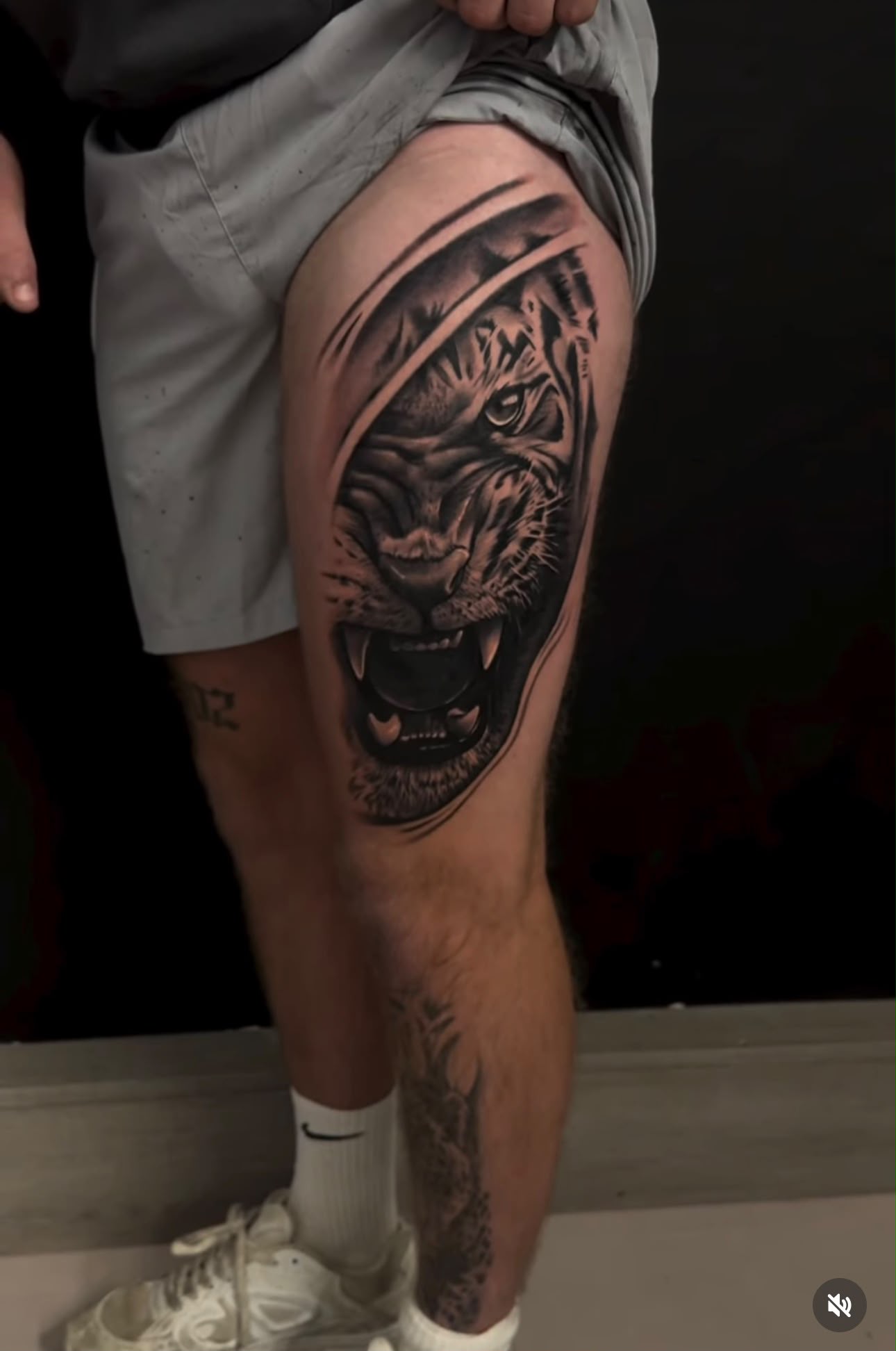 Roaring tiger thigh piece in black and grey realism