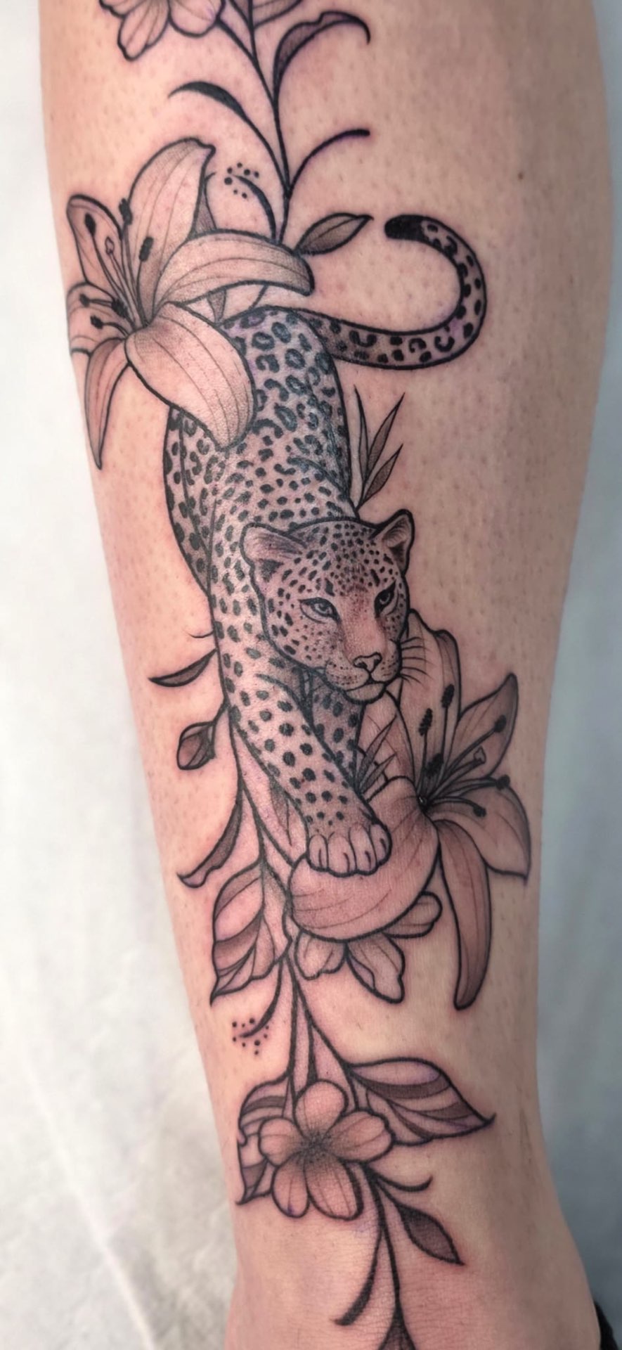 Fine line leopard and lilies leg piece